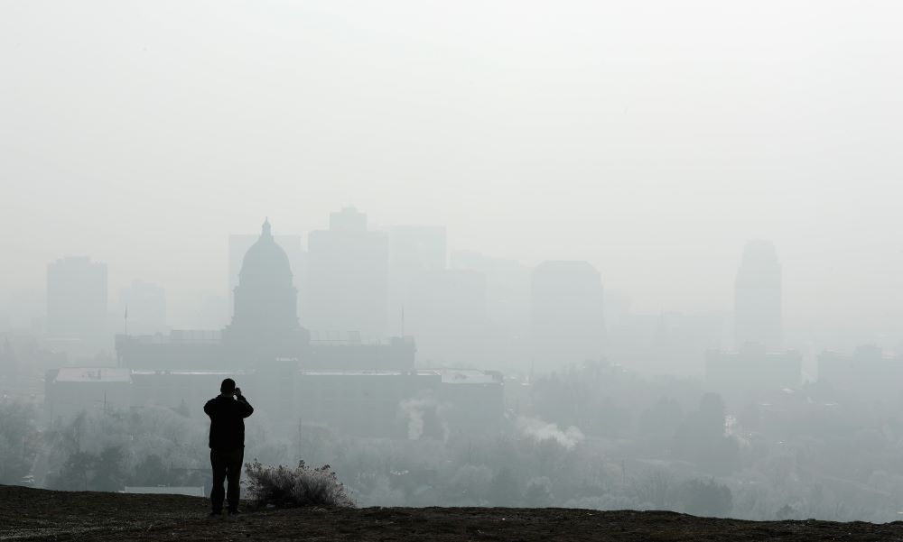 Person takes picture of building shrouded in smog. Person takes picture of building shrouded in smog.